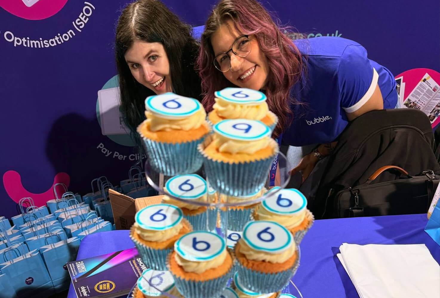 Bubble team members Toni and Asia behind some Bubble branded cupcakes